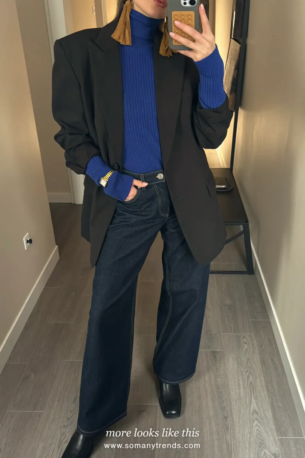Woman in a cobalt blue ribbed turtleneck, black blazer, dark wide-leg jeans and black ankle boots, outfit 3