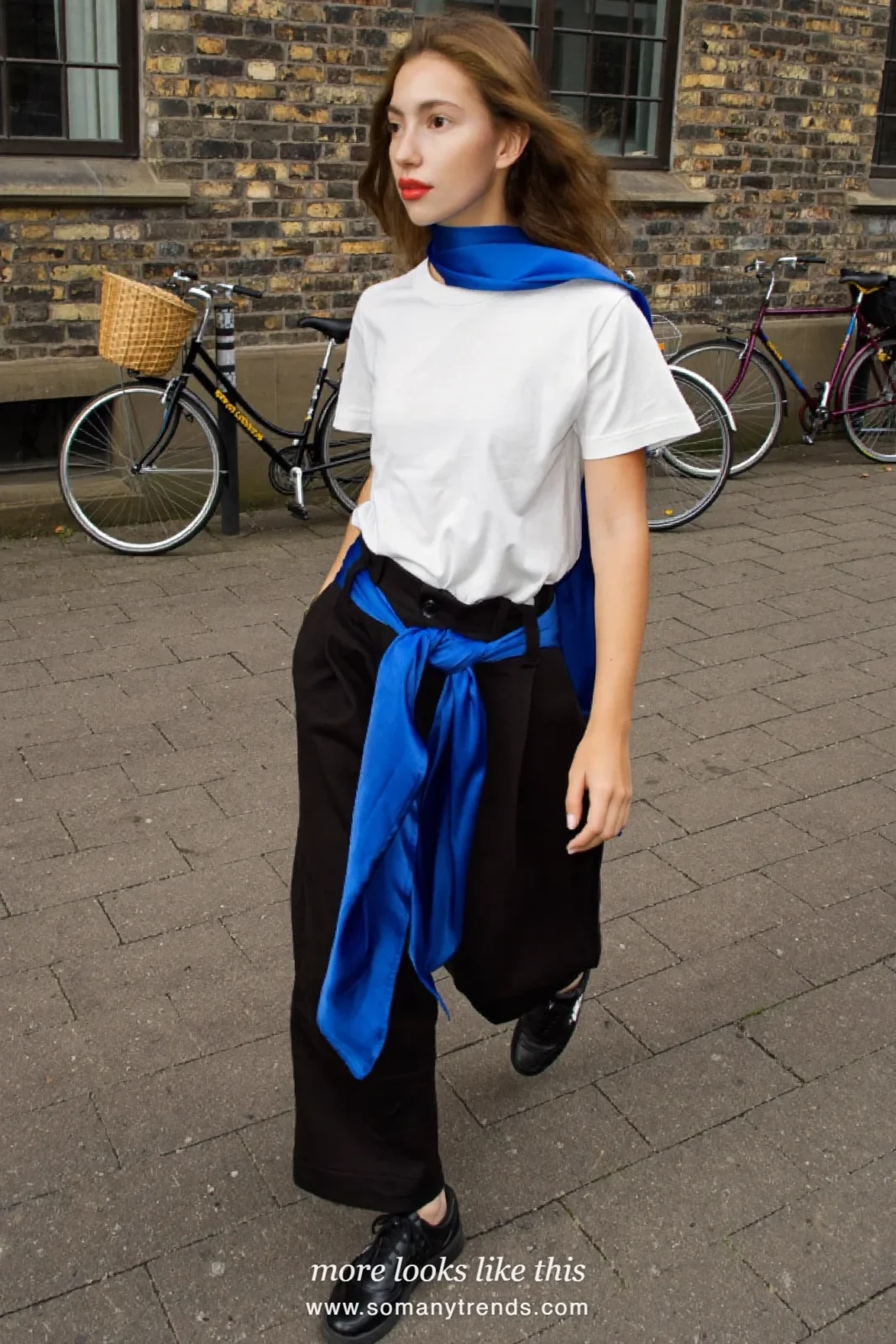 Woman in a white tee, black wide-leg pants with a cobalt blue silk scarf tied as a belt and black sneakers, outfit 4