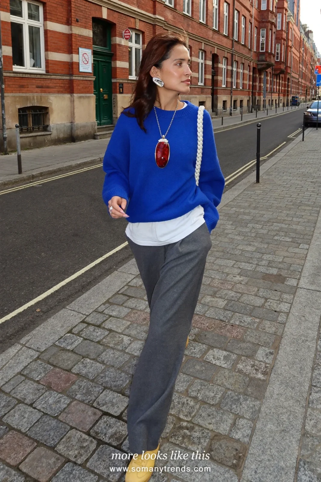 Woman in a cobalt blue sweater over a white tee, gray wool pants and butter yellow sneakers, outfit 11