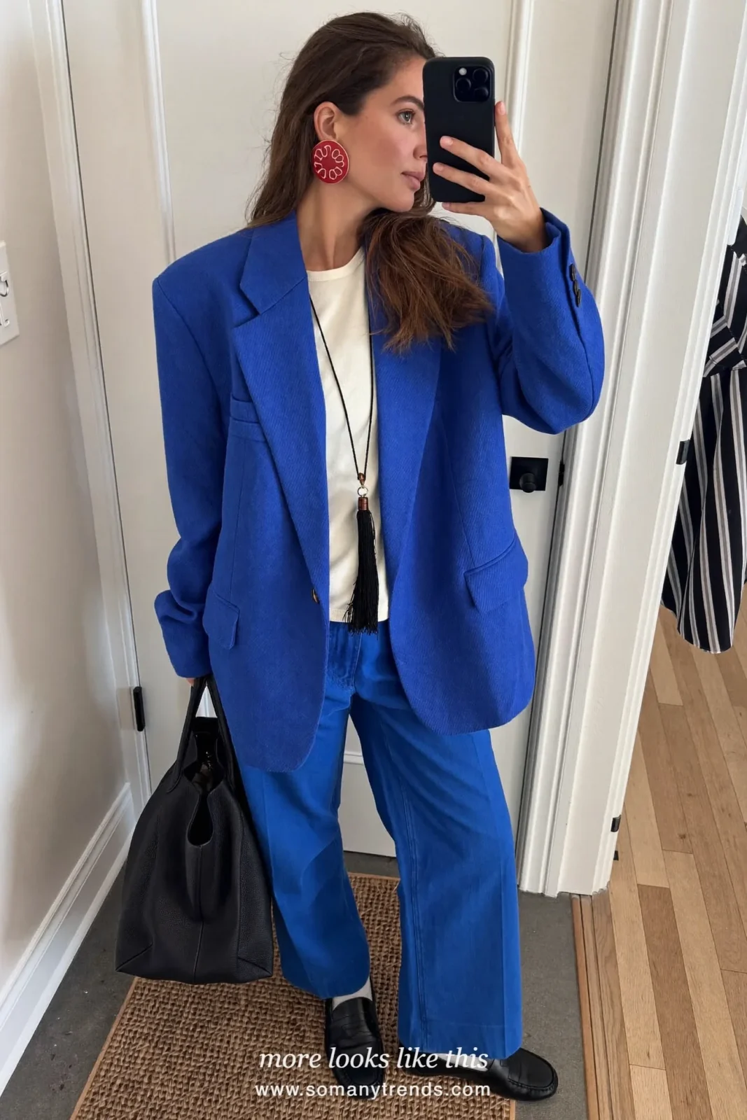 Woman in a cobalt blue blazer and wide-leg pants suit with a cream tee and black loafers, outfit 27