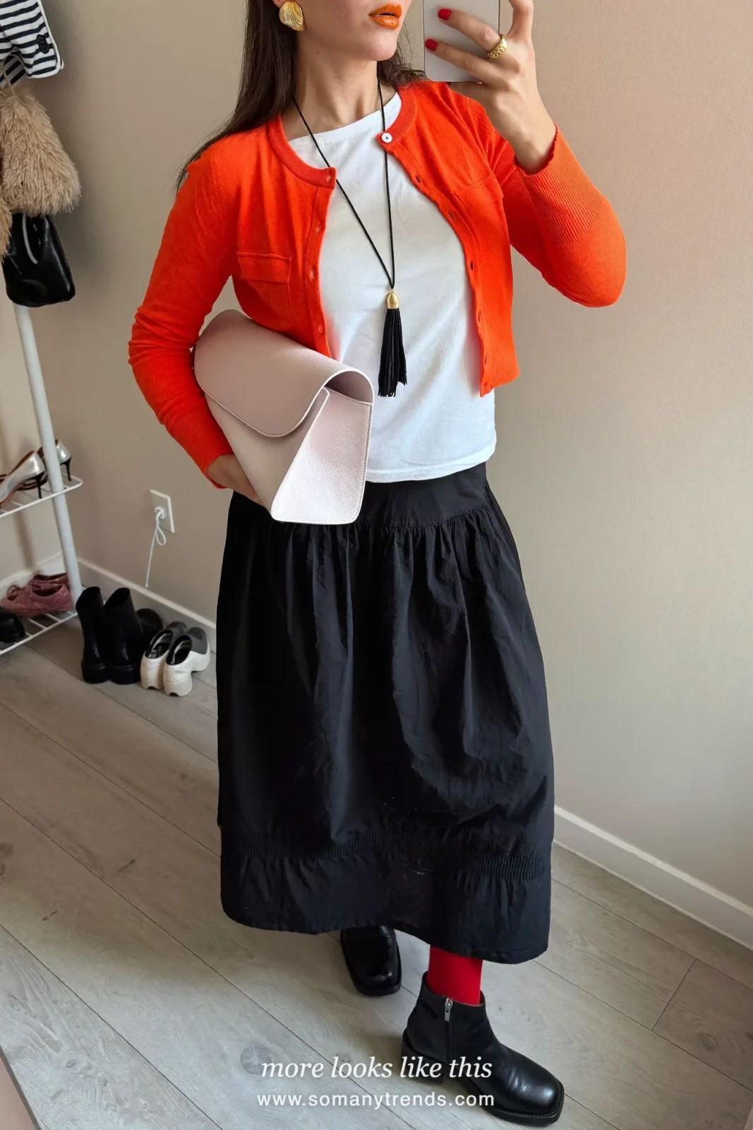 Red cardigan over white tee, black tiered maxi skirt, red tights, pink leather clutch and black ankle boots, outfit 3