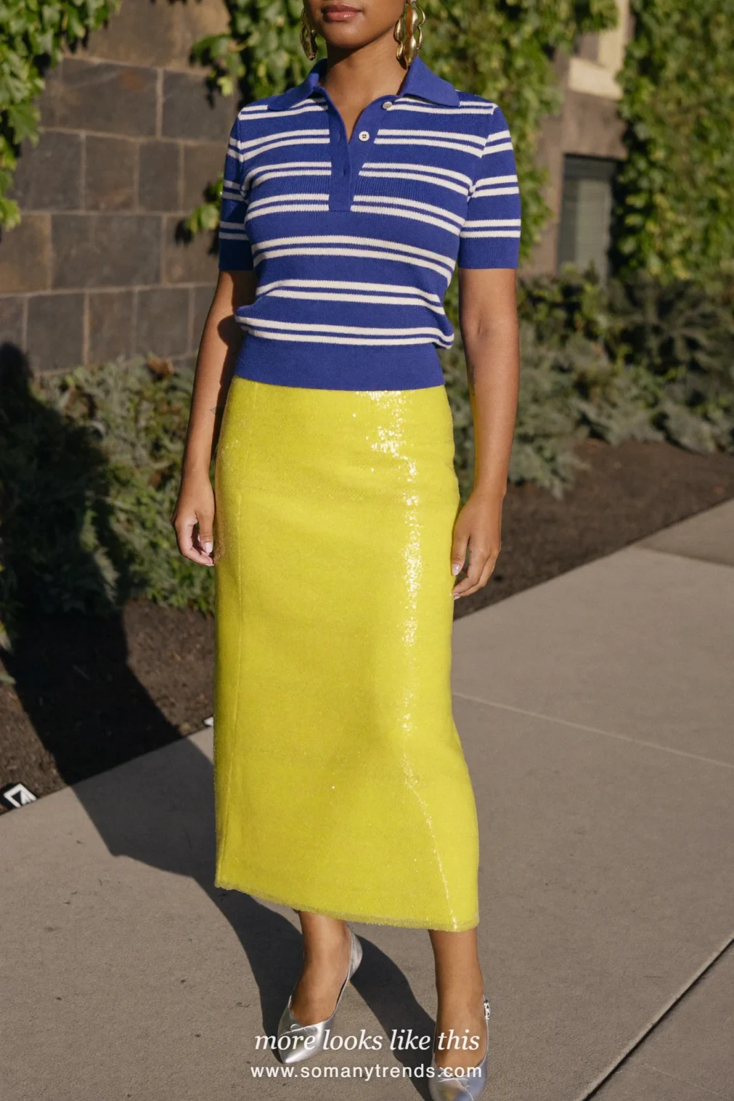 Woman in a blue and white striped knit polo, yellow sequin midi skirt and silver slingbacks at a bar door, outfit 14