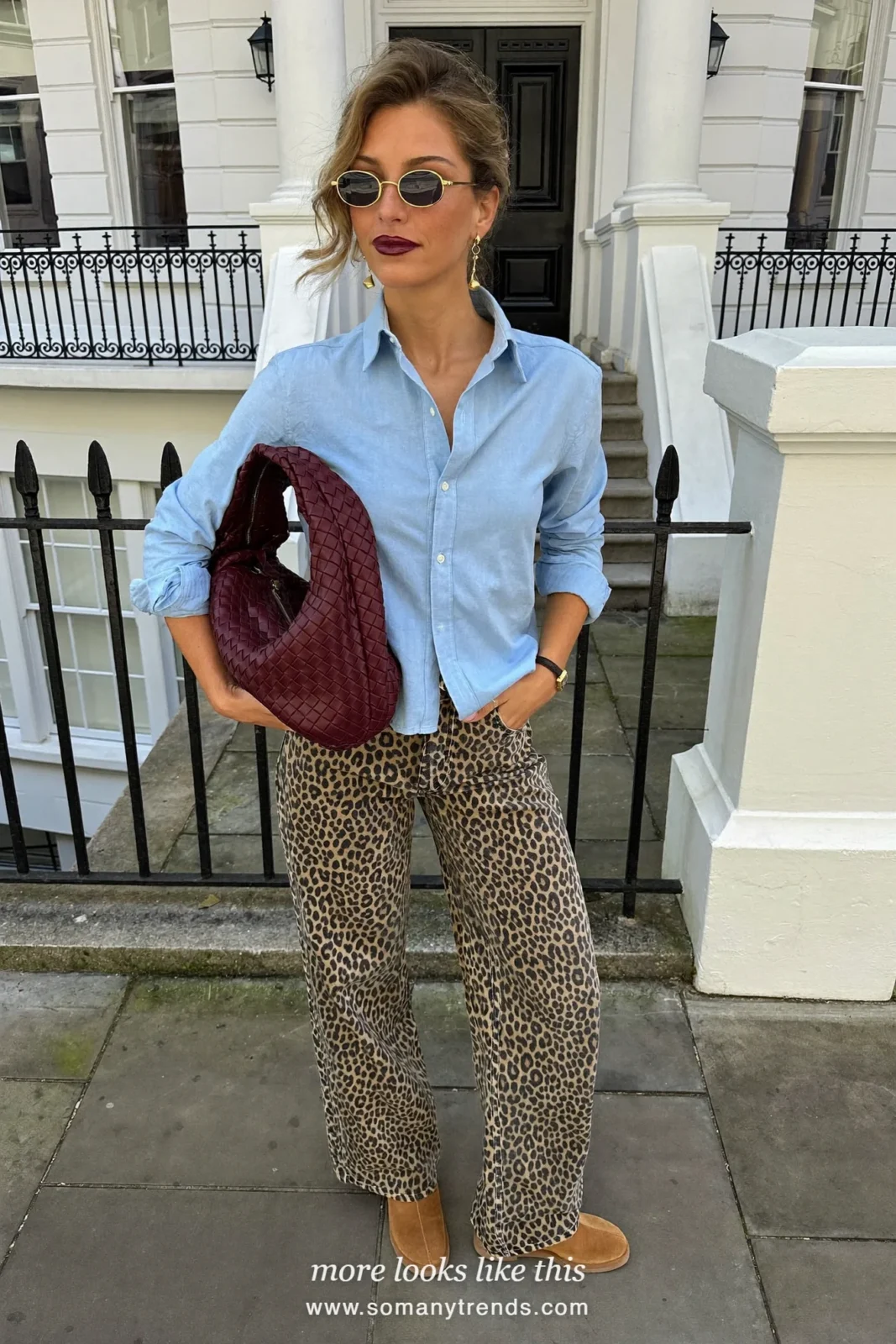 Woman in a chambray shirt, leopard print straight jeans, tan suede ankle boots and a burgundy woven hobo bag, outfit 5