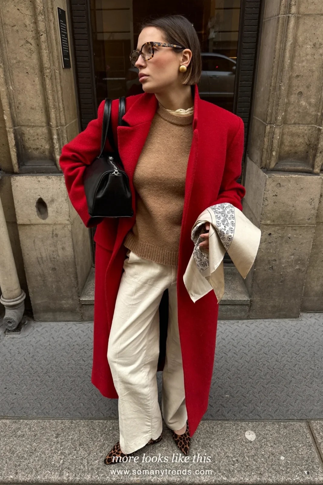 Woman in a cherry red wool coat, camel knit sweater, cream pants and leopard print pointed flats, outfit 9