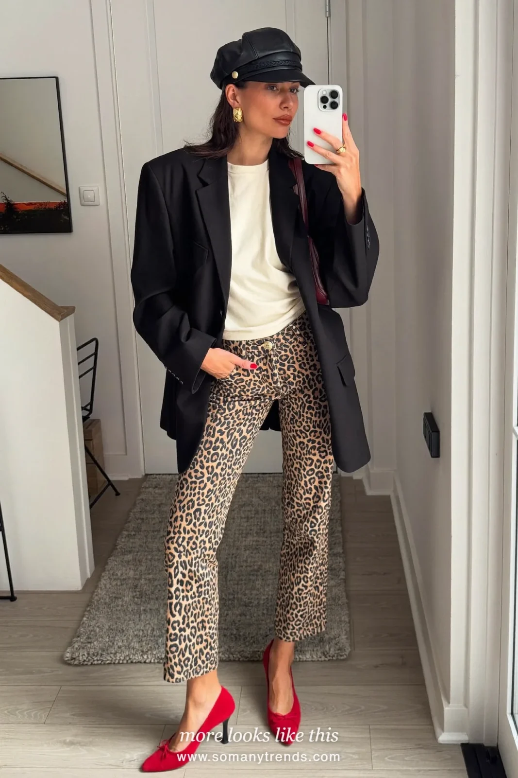 Woman in a cream tee, leopard print kick-flare pants, red low pumps and a black blazer, outfit 18