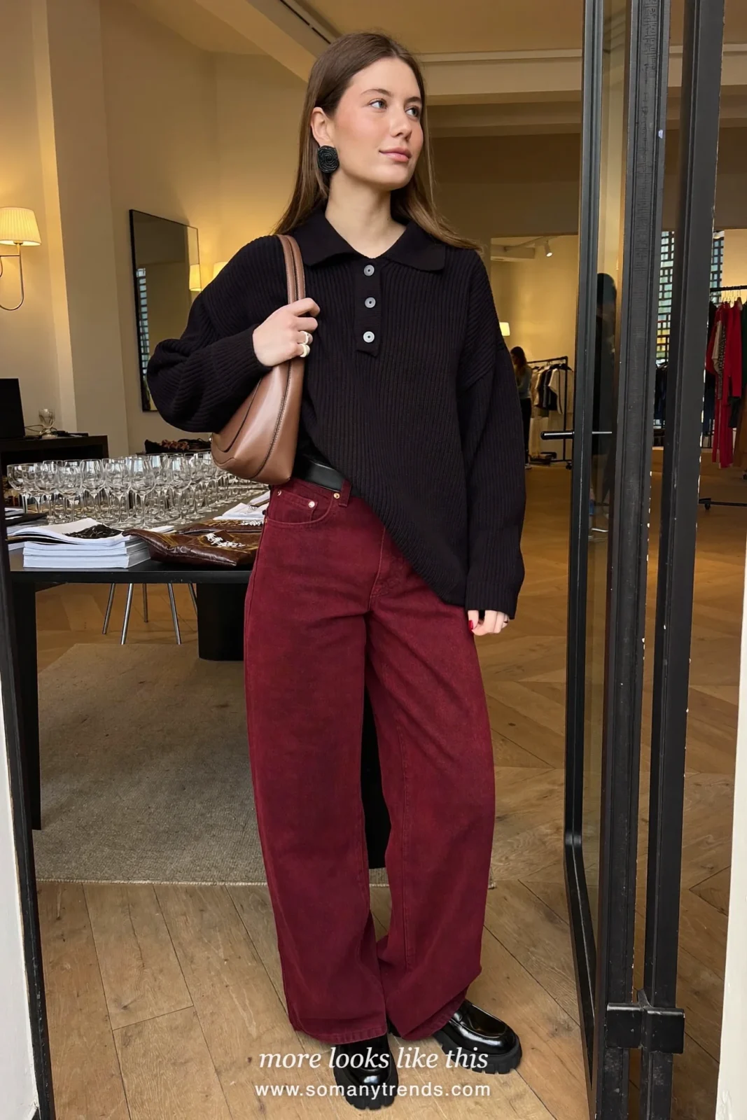 Woman in a black ribbed polo sweater, wide-leg burgundy jeans and black loafers, outfit 4