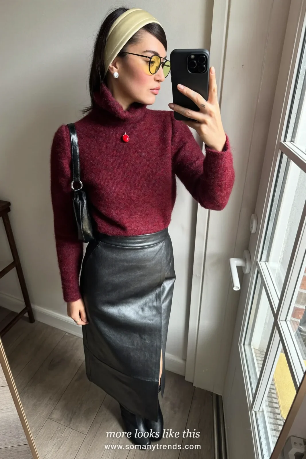 Woman in a burgundy cashmere turtleneck, black leather midi skirt and black knee-high boots, outfit 9