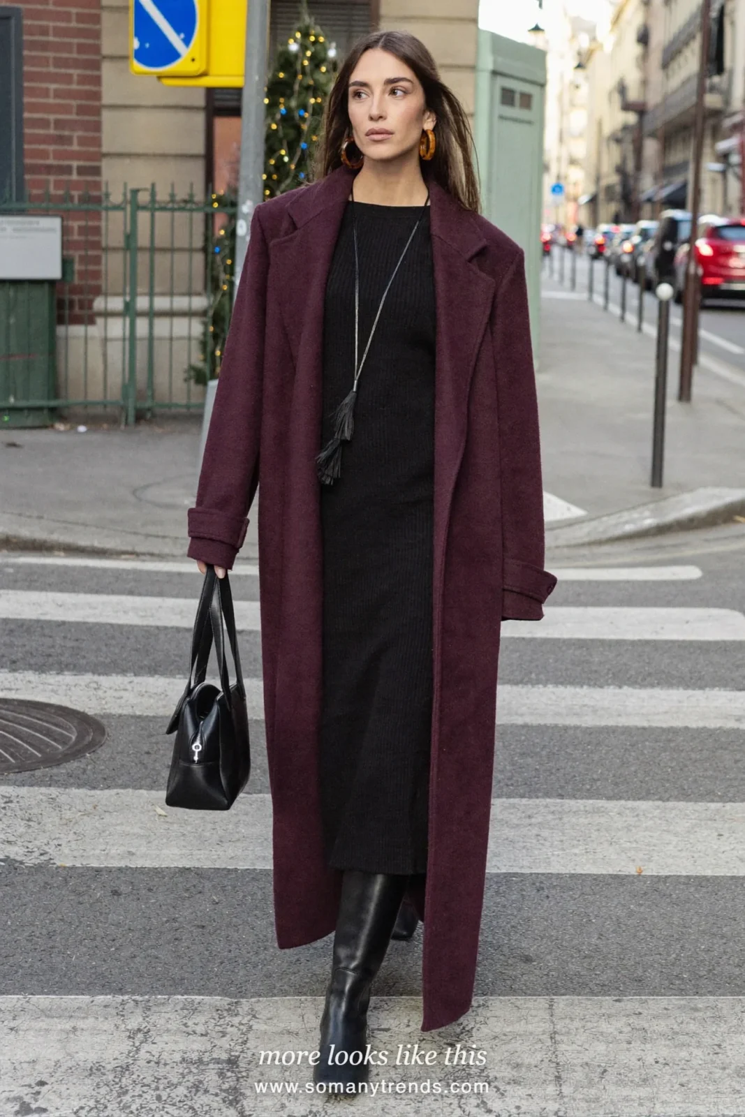 Woman in a long burgundy wool coat over a black midi dress and black tall boots, outfit 20