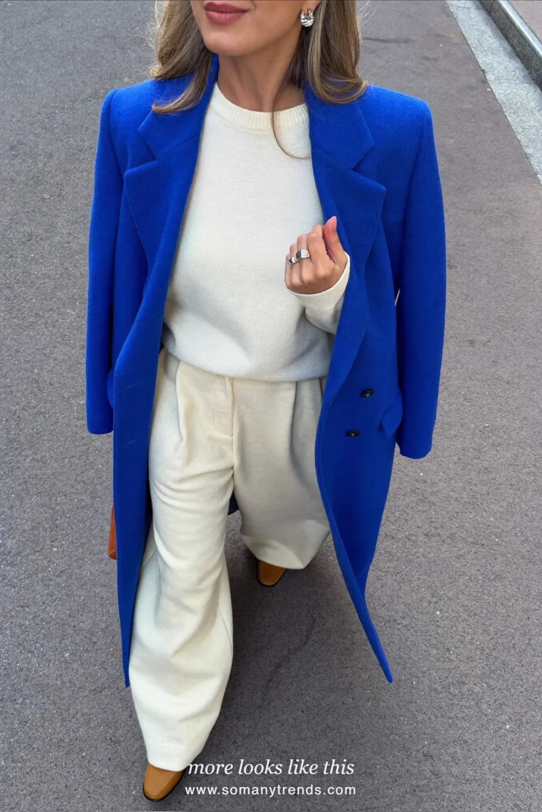 Look 23: cobalt wool coat, cream knit sweater, cream wide-leg pants and tan loafers