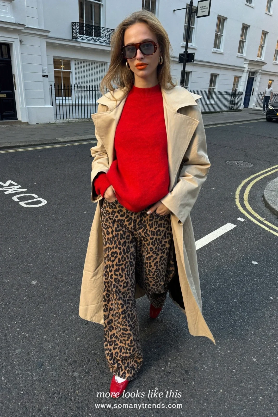 Woman in a beige trench coat, cherry red crewneck sweater, leopard print wide-leg jeans and red ballet flats, outfit 1