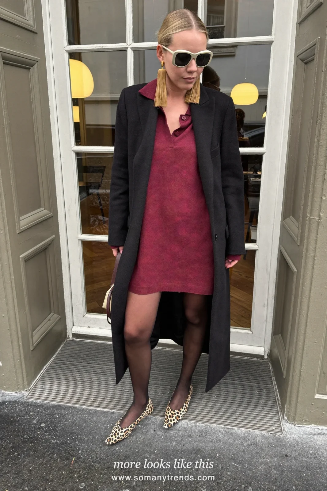 Woman in a loose burgundy knit dress, black tights, leopard print pointed flats and a black wool coat, outfit 20