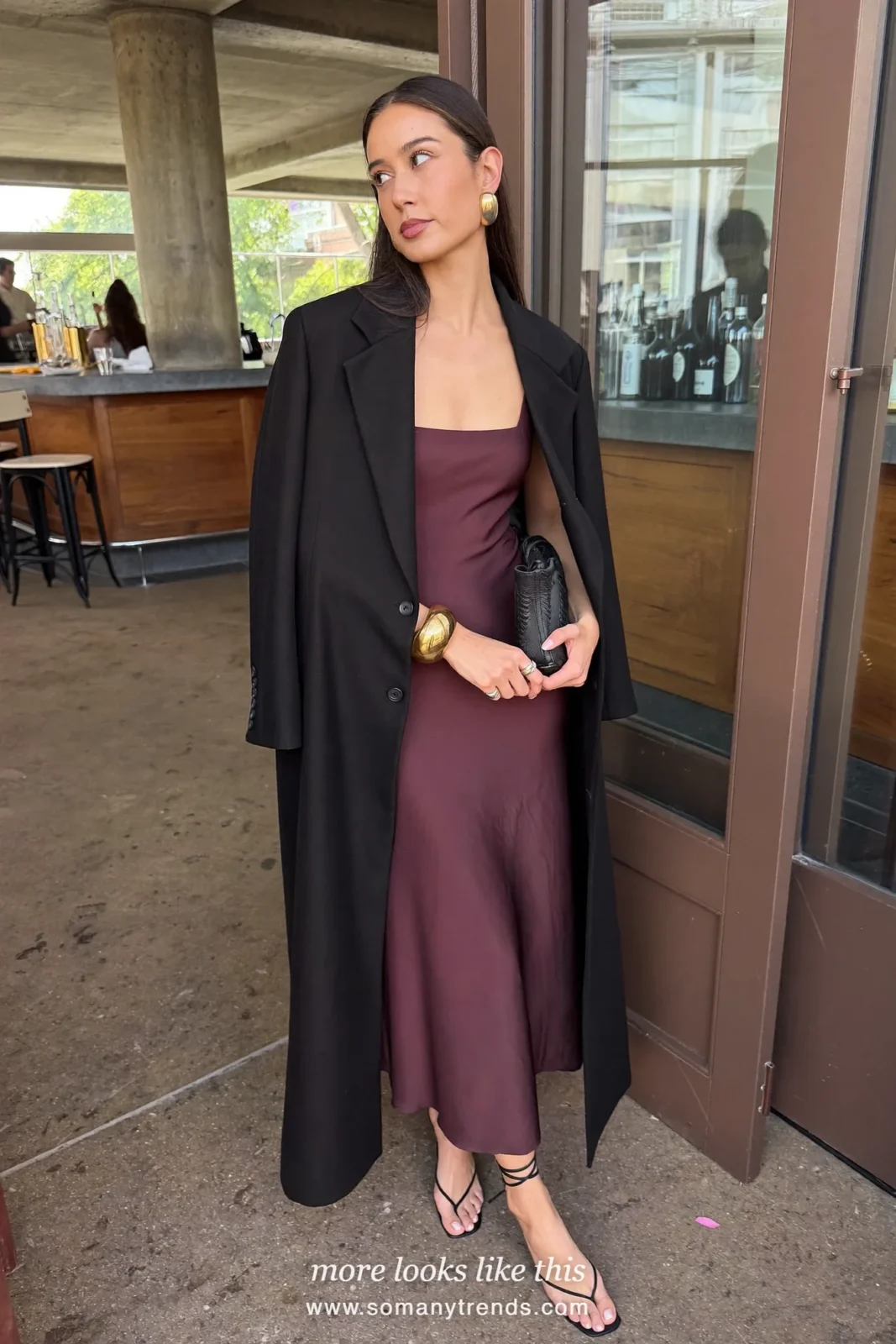 Woman in a black velvet blazer over a deep burgundy satin slip dress with black heels, outfit 2