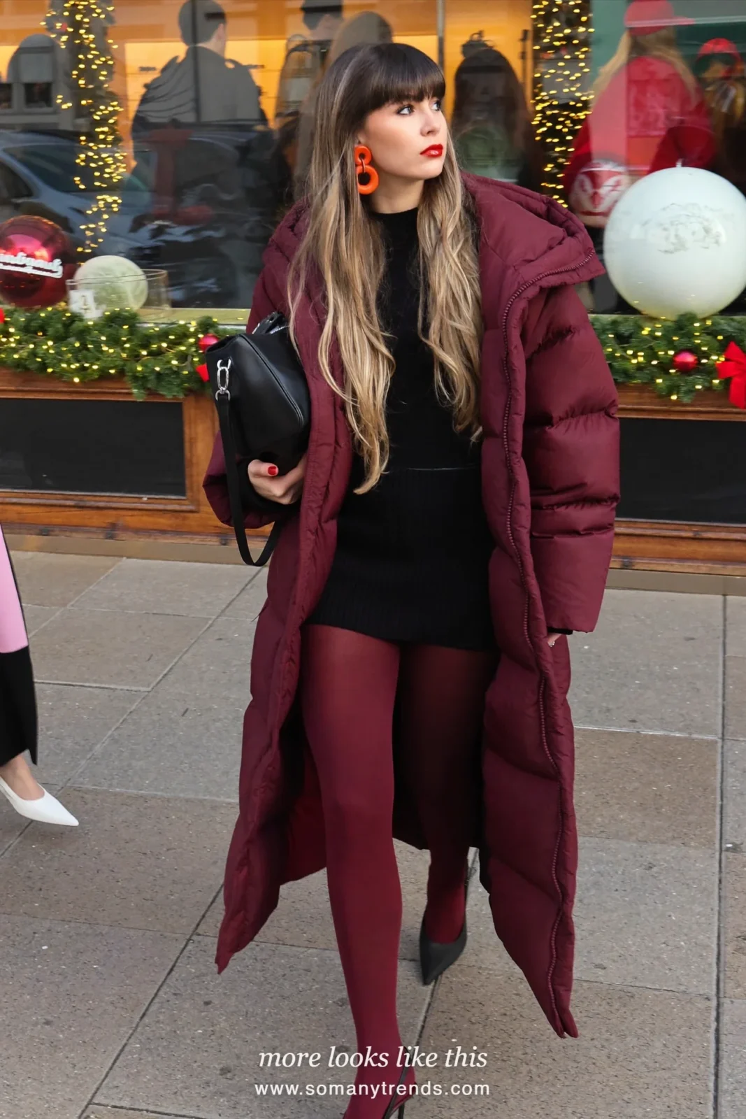 Woman in a long burgundy puffer coat with burgundy tights and black slingback pumps, outfit 11
