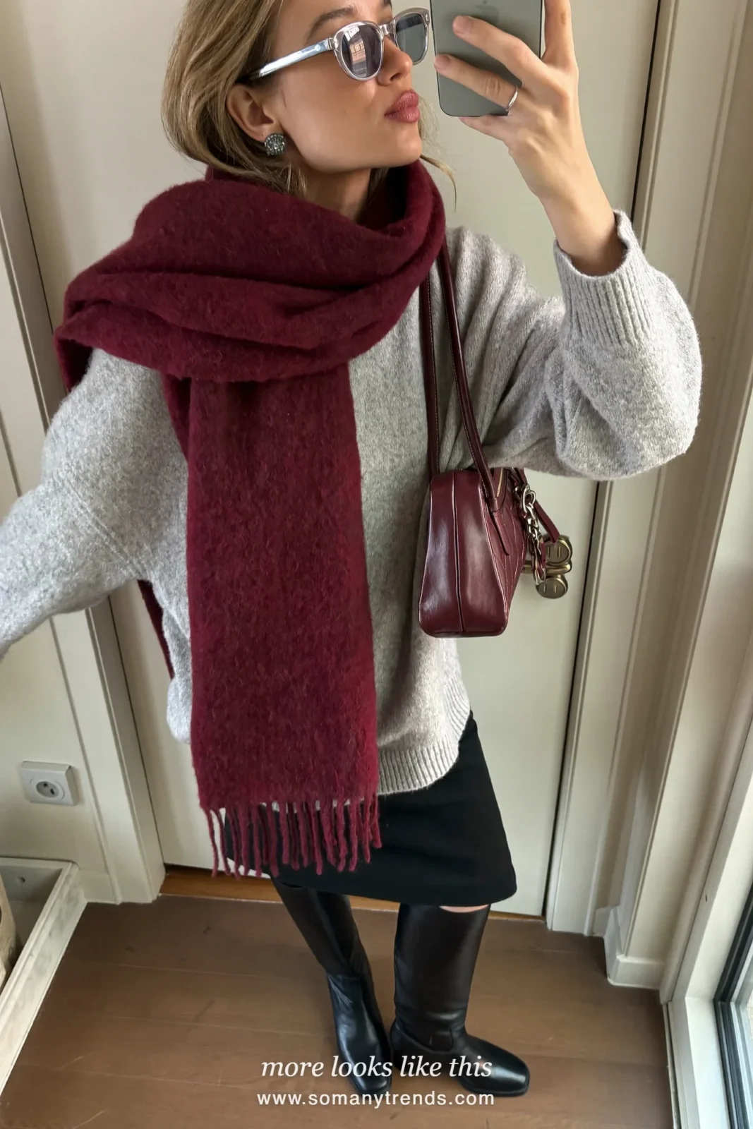 Woman in a gray knit sweater, black midi skirt, burgundy scarf and black tall boots, outfit 24