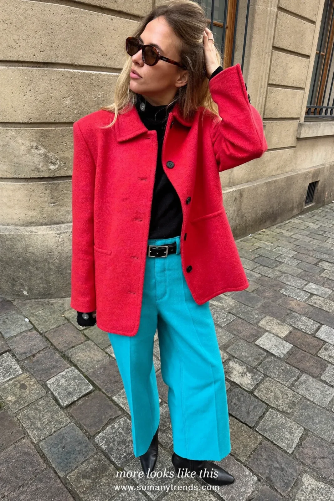 Woman in a short coral red wool coat, black knit, wide aqua pants and black boots, outfit 8