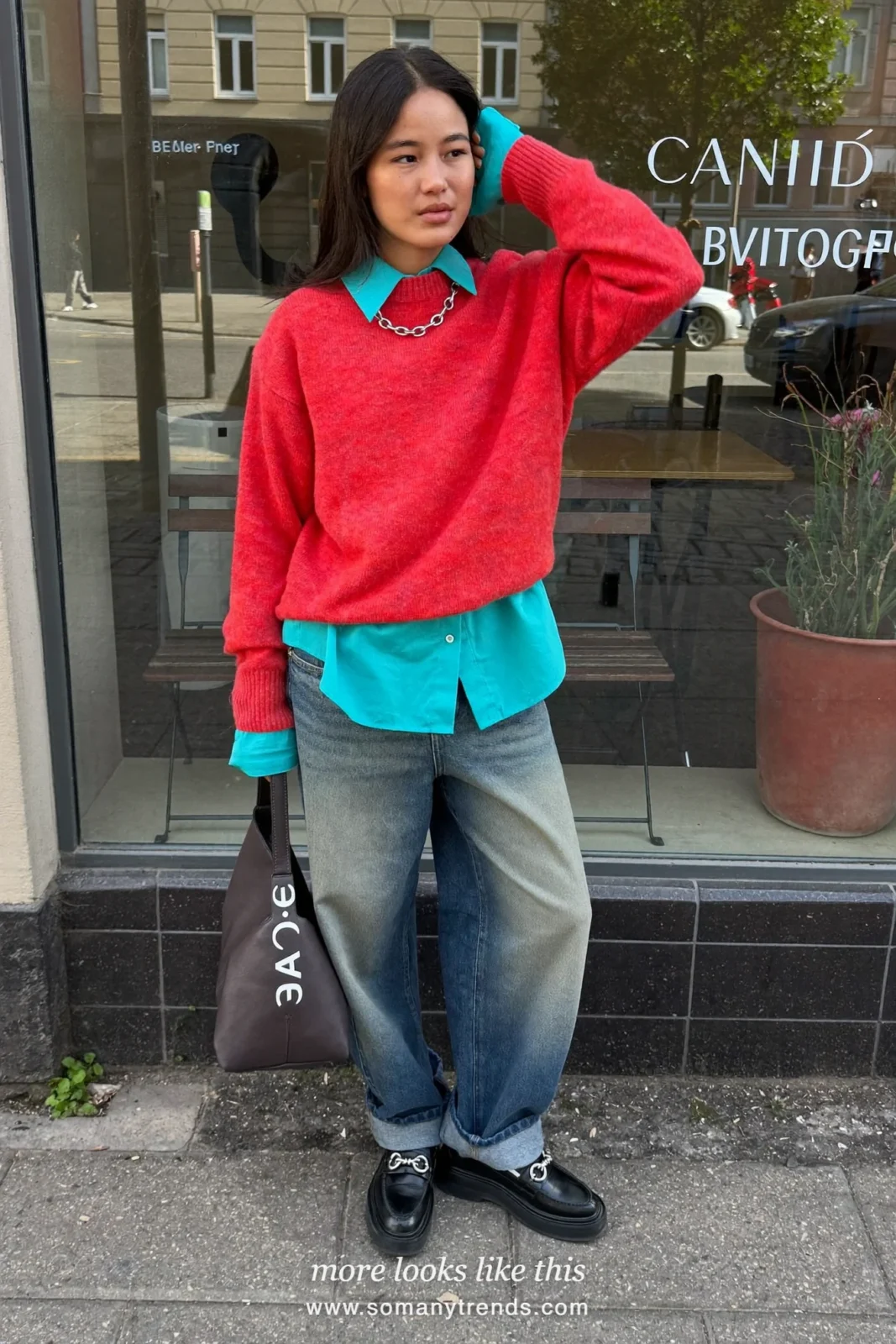 Woman in a coral red crewneck sweater, aqua shirt with collar out, straight jeans and loafers, outfit 11