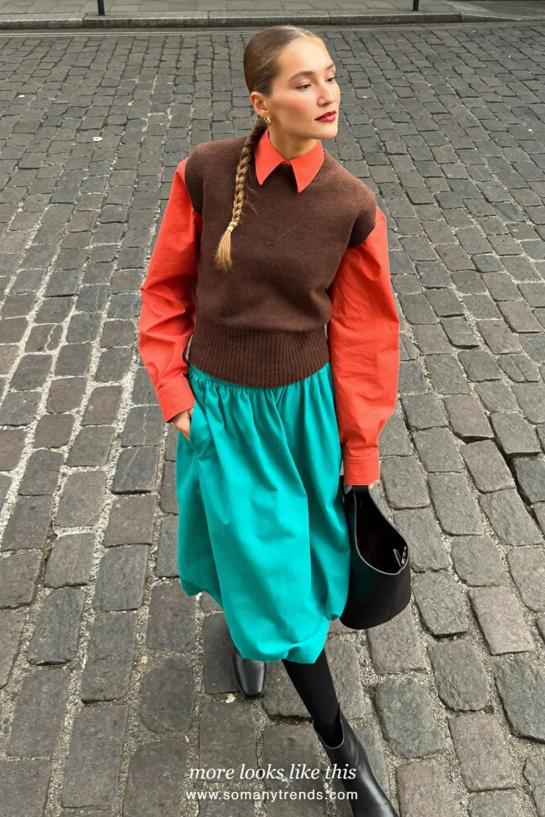 Woman in a brown knit vest, coral red shirt, aqua A-line midi skirt and black boots, outfit 17