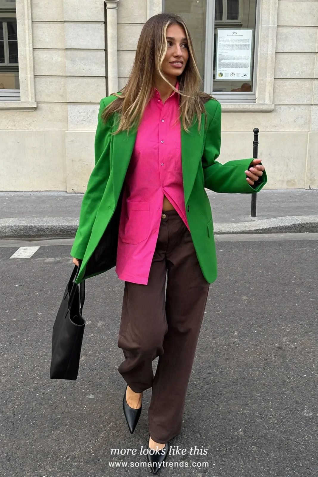 Woman in a moss green relaxed blazer, bright pink button-down shirt, chocolate brown wide-leg pants and black pointed pumps, outfit 5