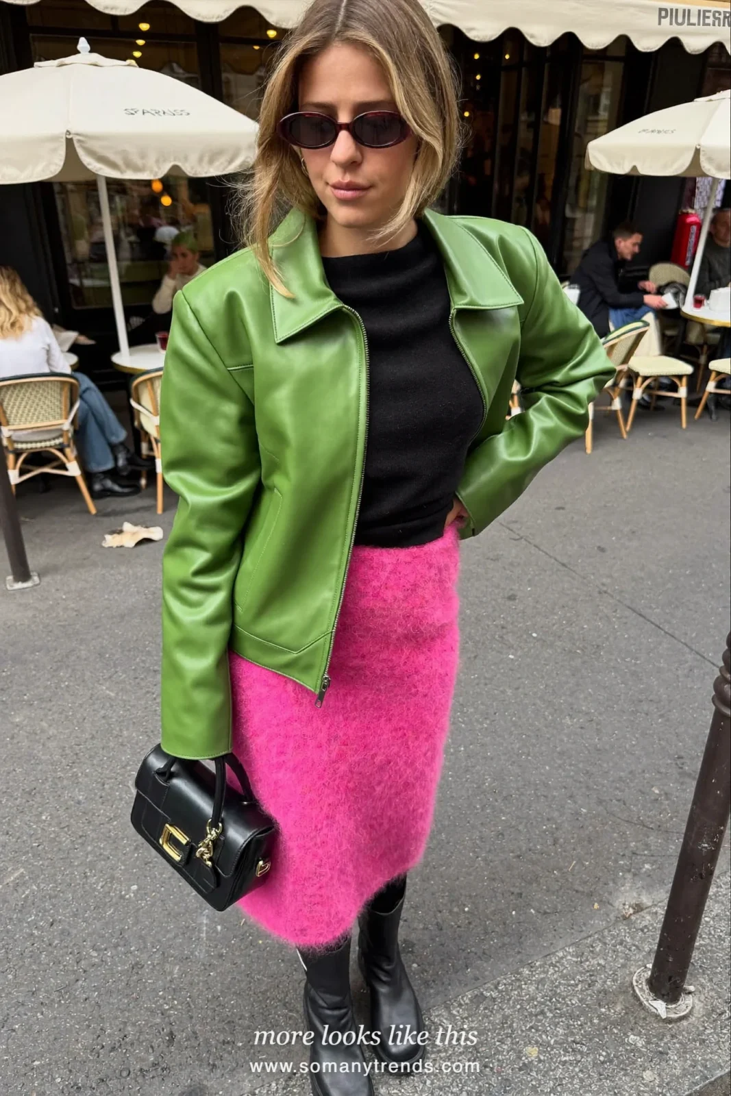 Woman in a bright pink mohair midi skirt, moss green leather jacket, black knit top and black chunky boots, outfit 9