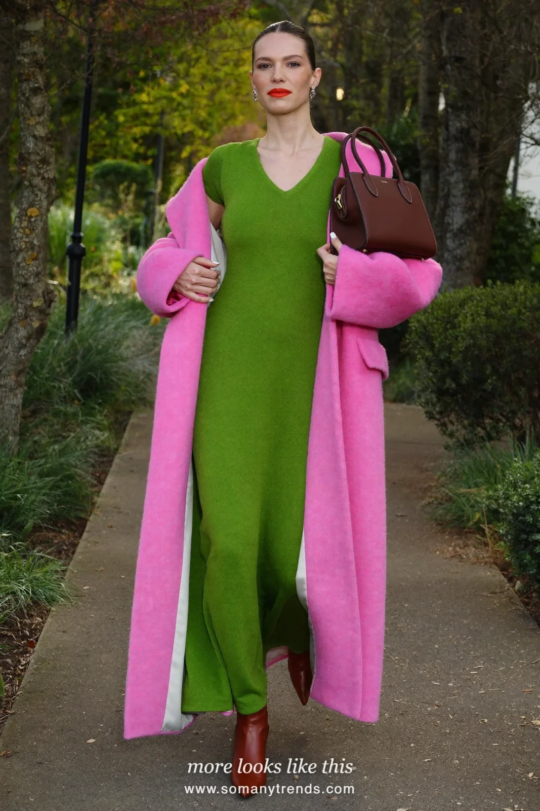 Woman in a bright pink long wool coat over a moss green loose knit maxi dress and brown boots, outfit 15