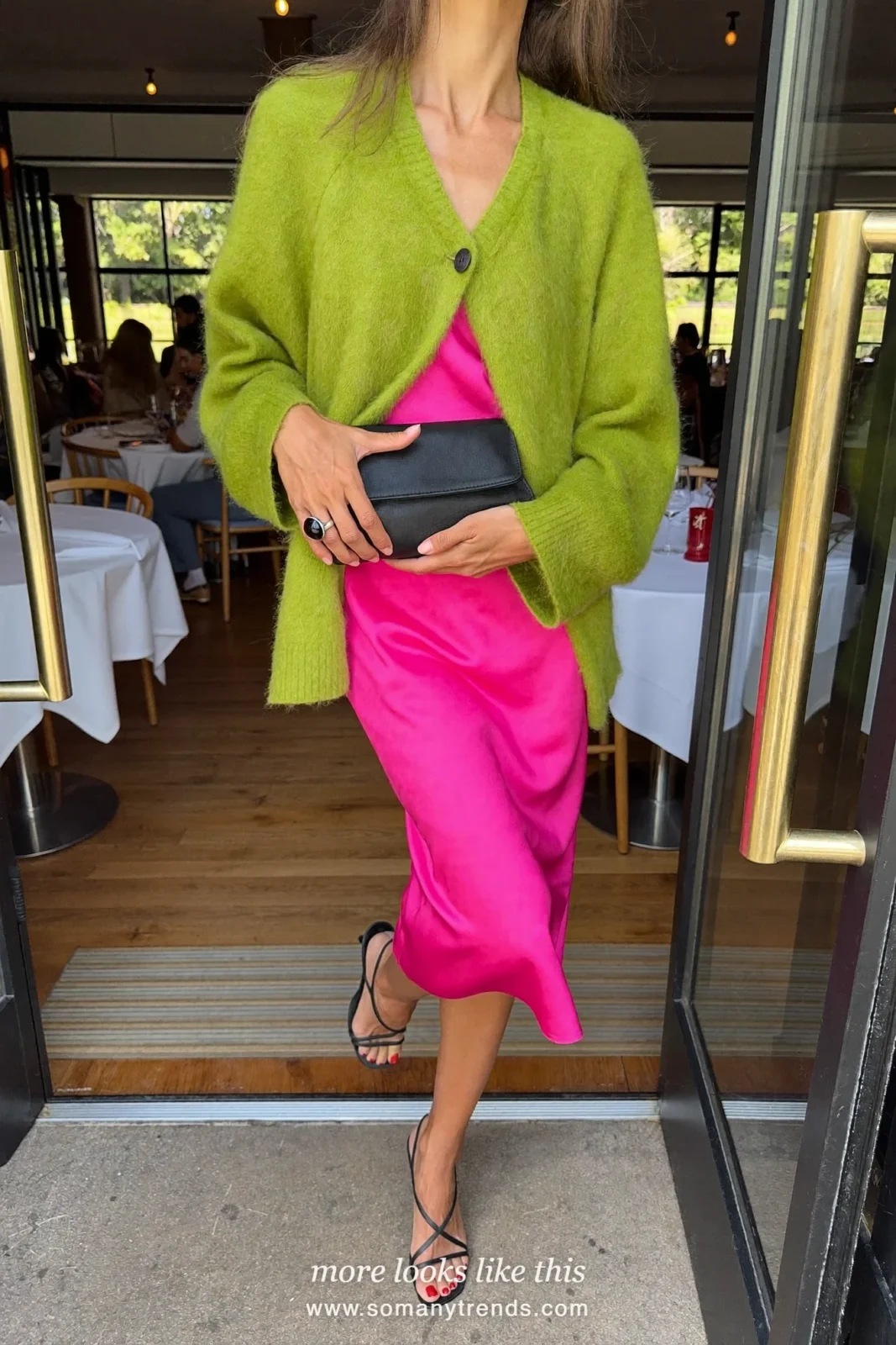 Woman in a bright pink midi dress, oversized moss green cardigan and black strappy heels, outfit 19